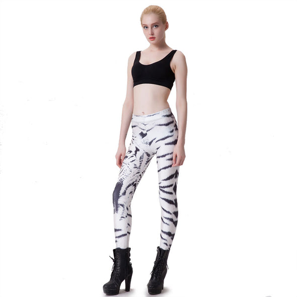 Model wearing black halter top and white leggings with black tiger stripes