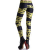 Rear view of Model wearing black leggings with "Police Line do not cross" tape printed on it